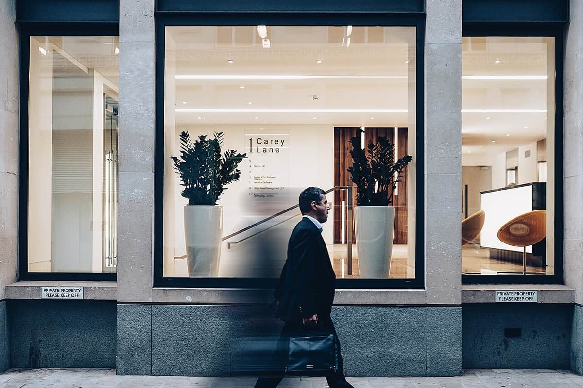 A traveler walking through a city with luggage
