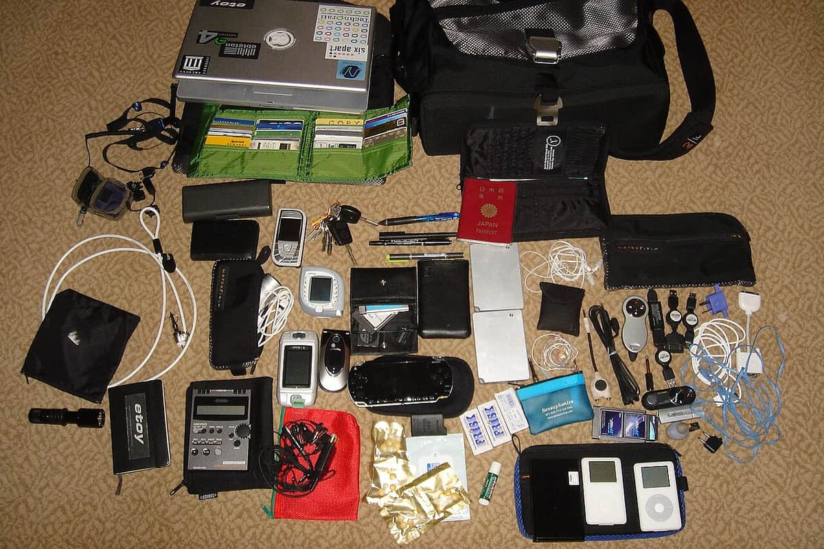 The full contents of a travel bag laid out flat on a floor