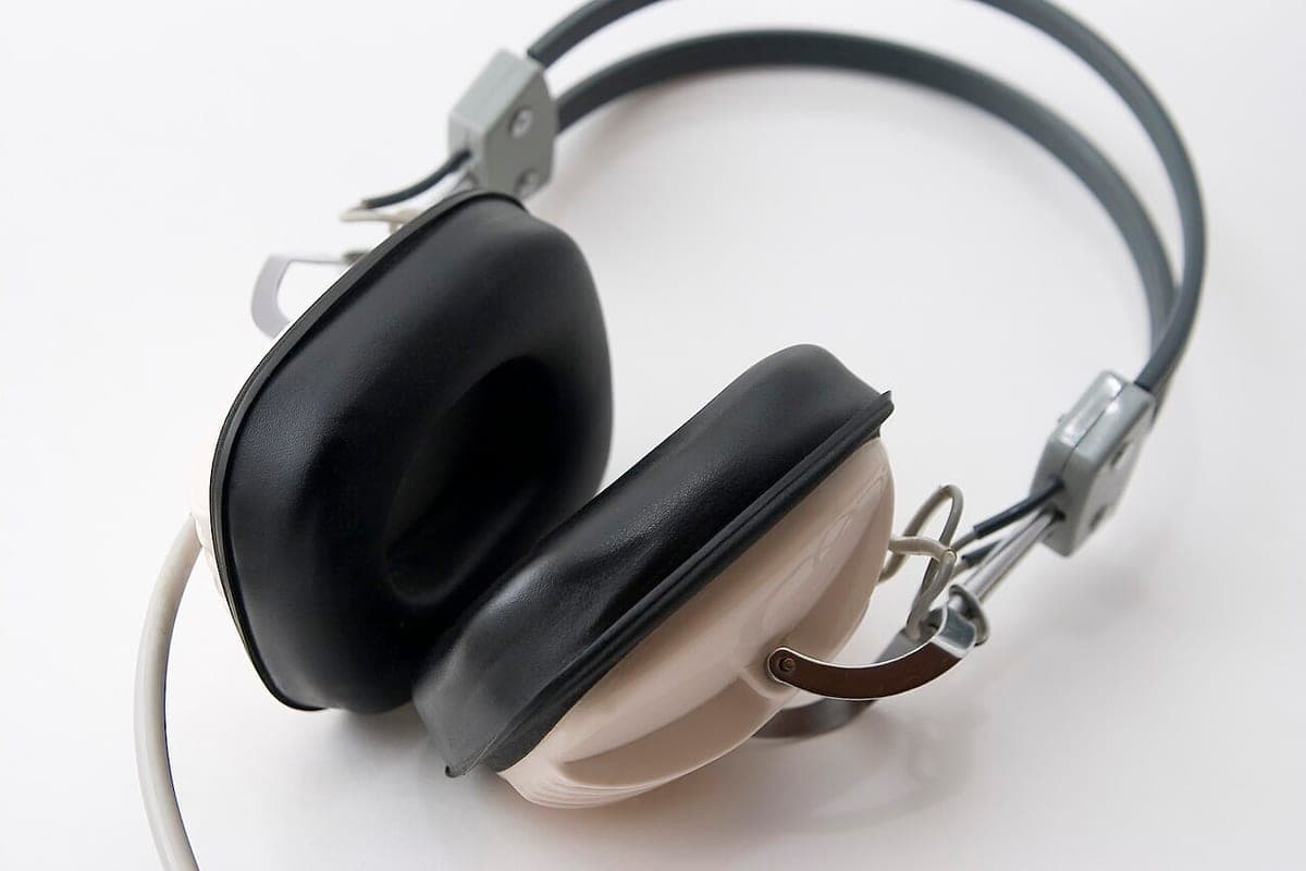 A pair of over-ear headphones resting on a light surface