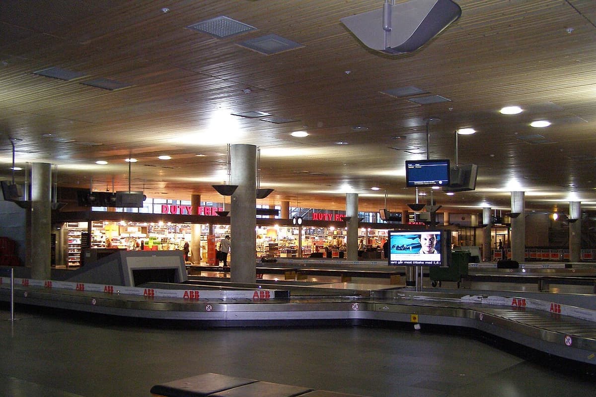 Suitcases circling on an airport baggage claim carousel