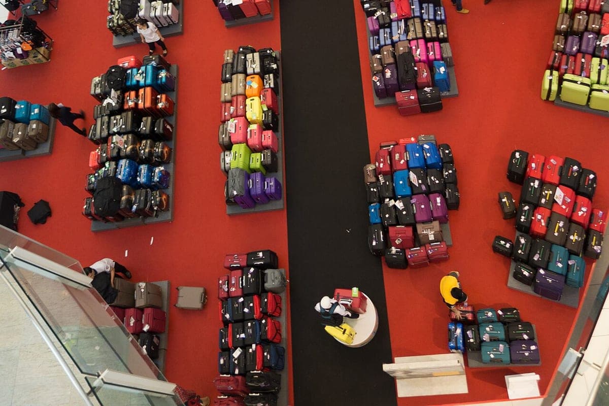 A wall of suitcases and bags on display in a luggage shop