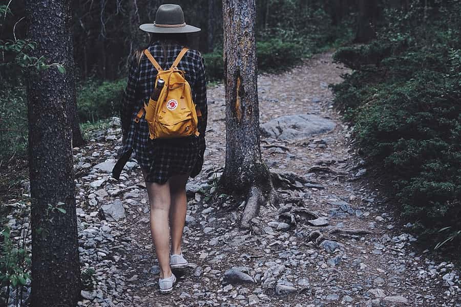A large travel backpack propped against a wall