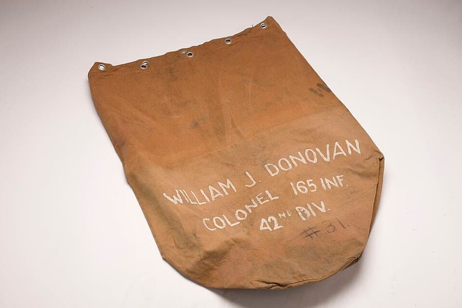 A canvas duffel bag photographed against a plain background