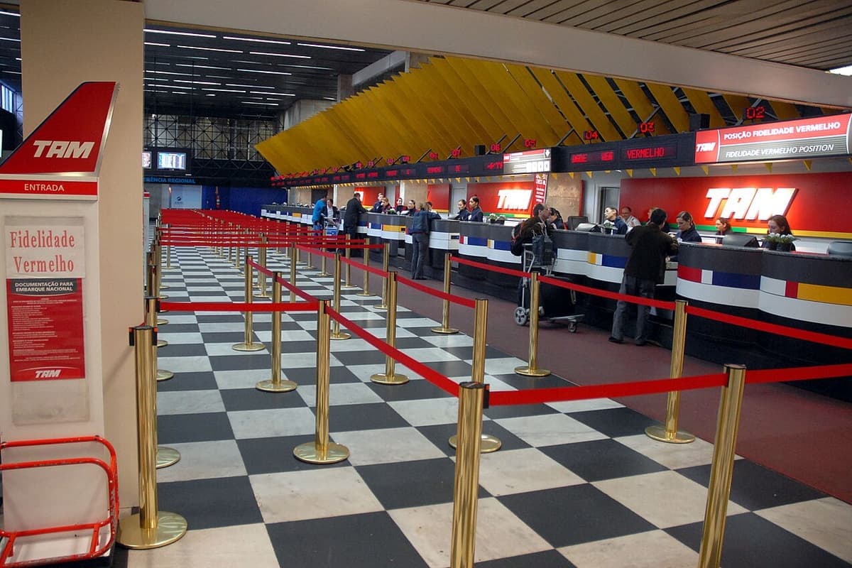 Passengers queuing at an airline check-in counter