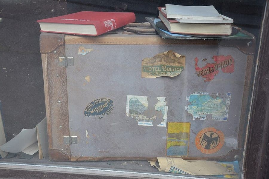 A suitcase standing on a street