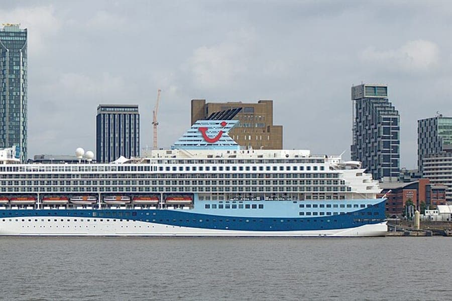 A cruise ship moored alongside a city waterfront