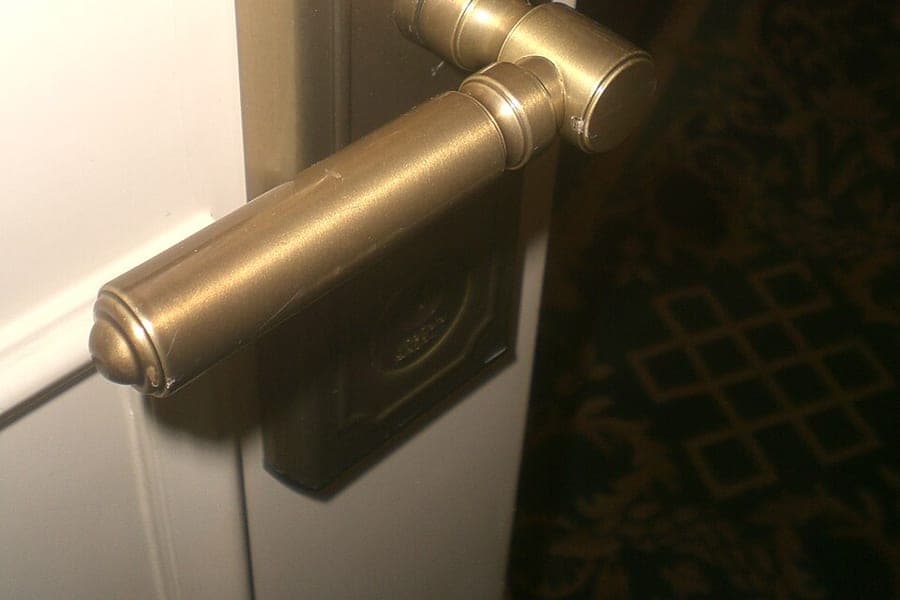 A hotel room door with a keycard reader