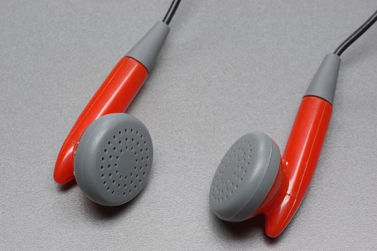 A pair of wired earphones on a plain background