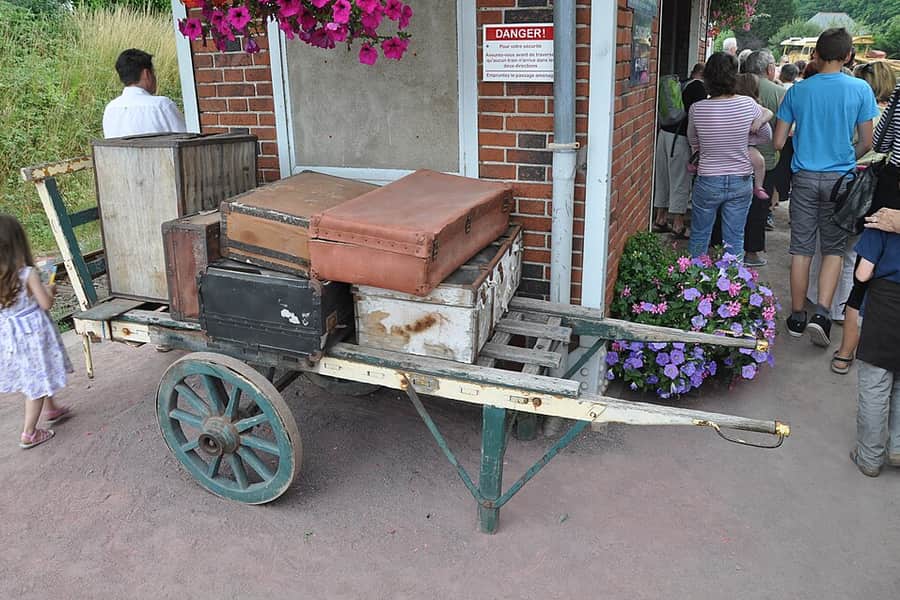 Old suitcases stacked in a wheelbarrow