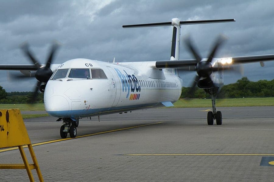 A regional airliner at an airport stand