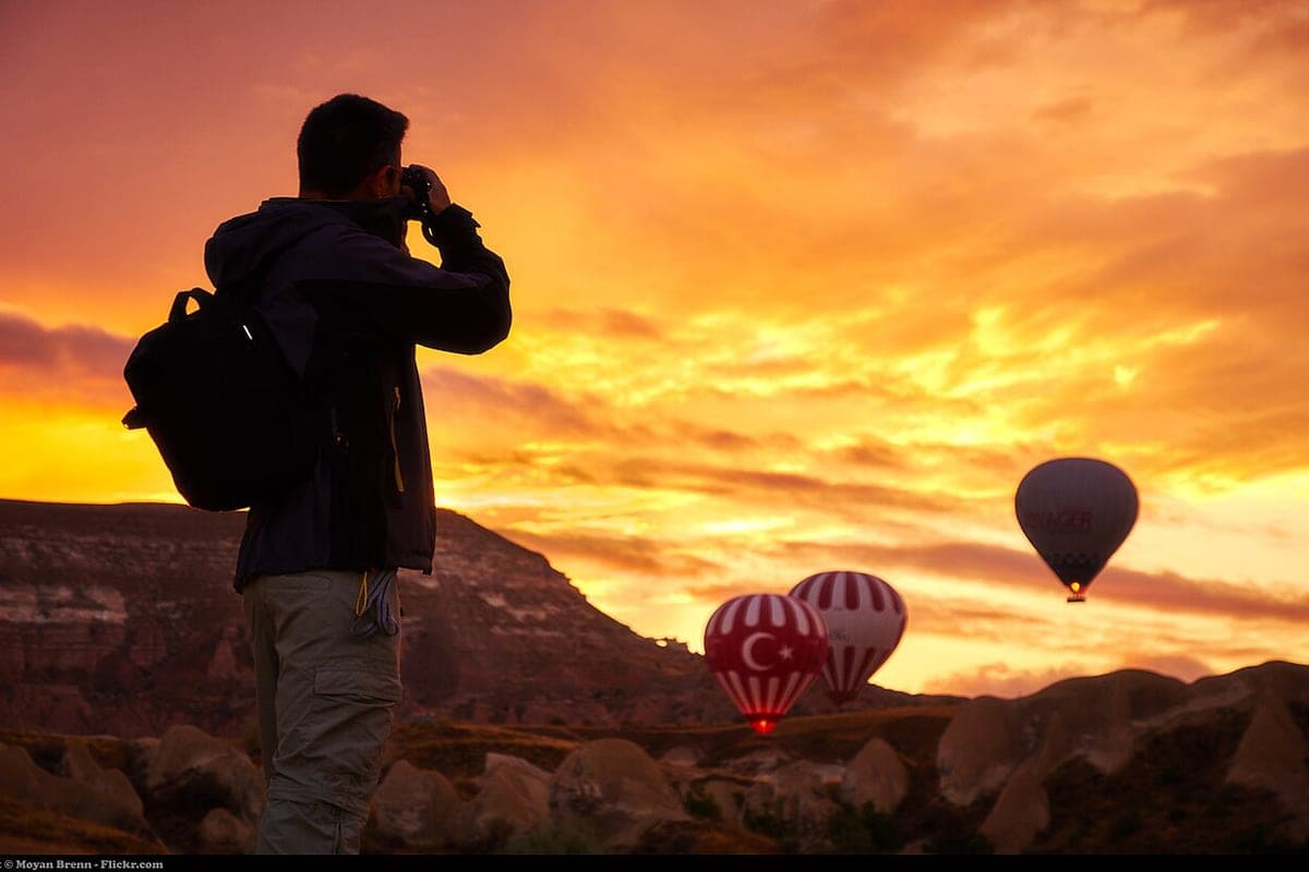 A traveler carrying a backpack at sunrise