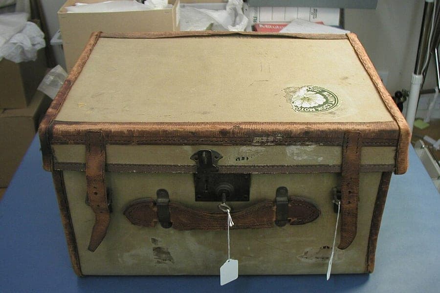 A hardshell suitcase standing on an airport floor
