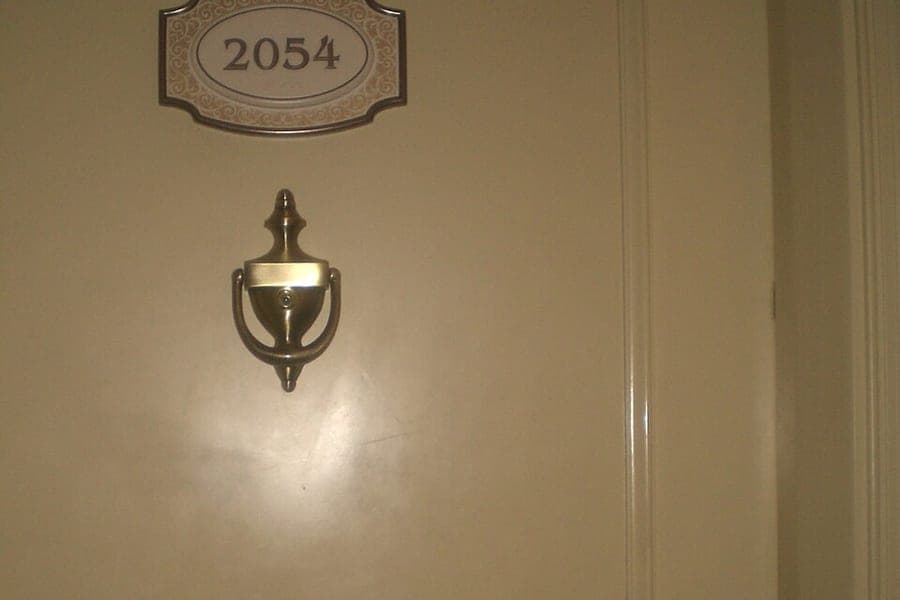 A hotel corridor with room doors