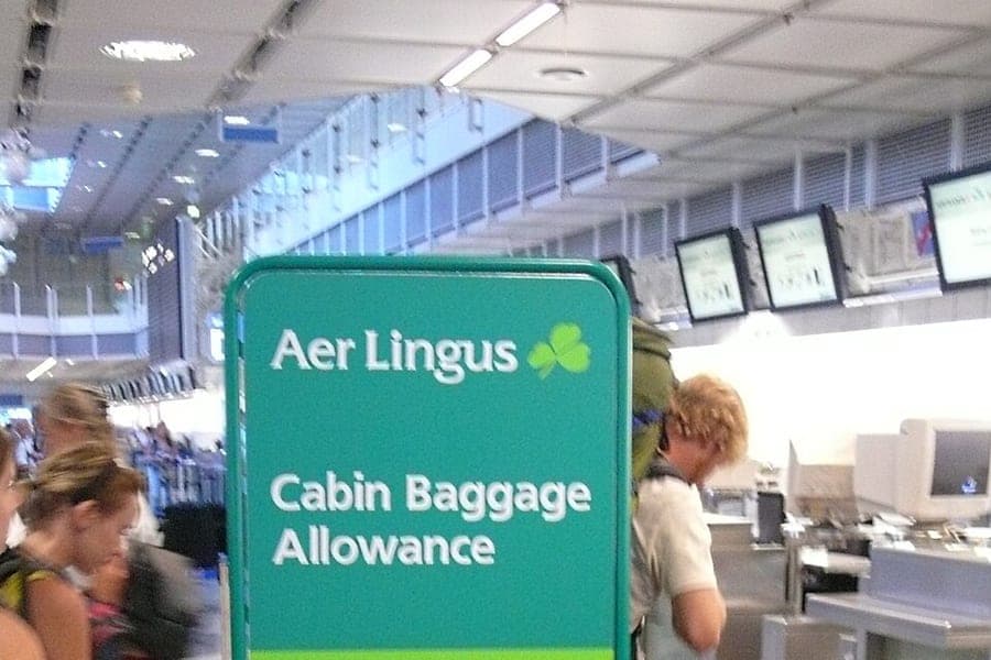 Suitcases stacked beside a measuring gauge