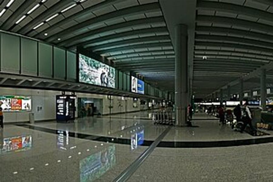 Checked suitcases on an airport baggage belt