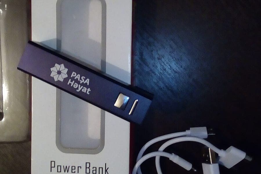 A portable power bank charging a device