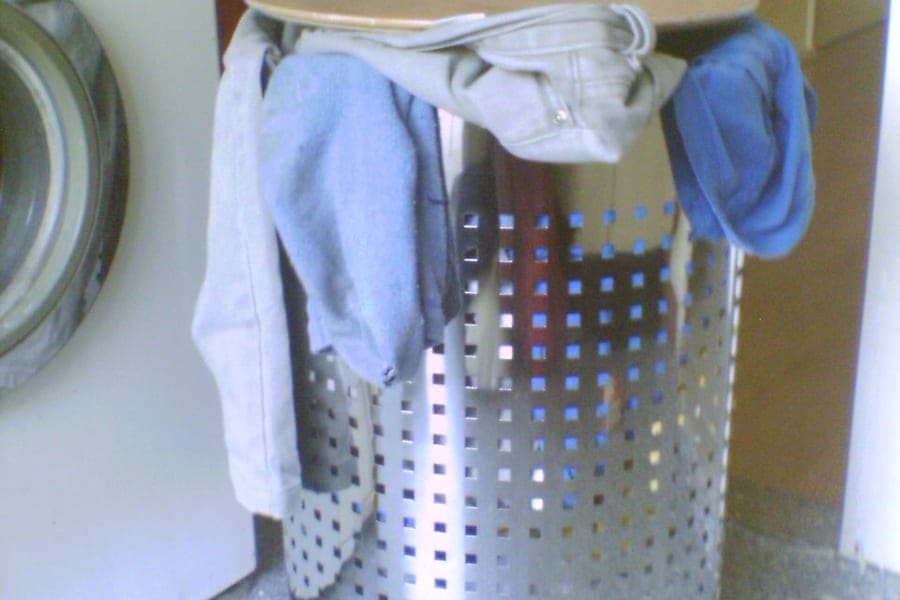 A woven laundry basket holding clothes