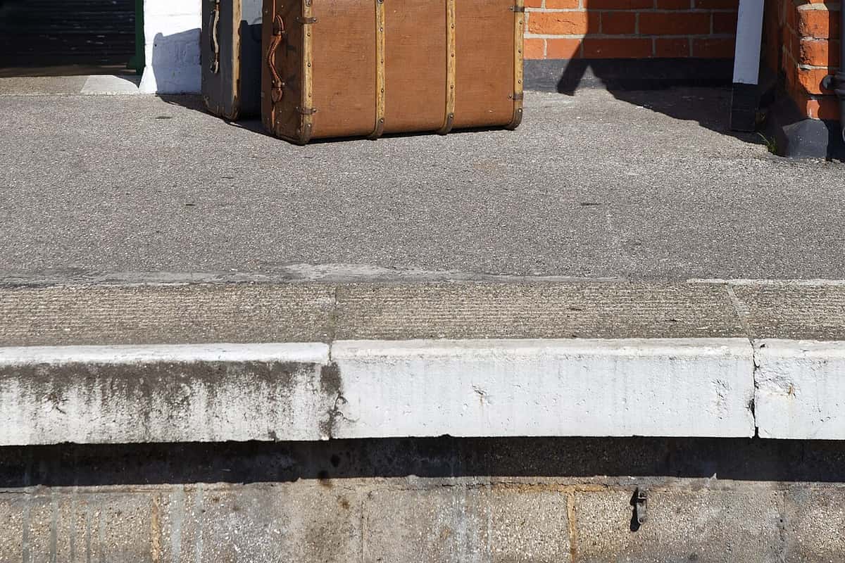 Old leather-bound luggage trunks stacked on a railway platform