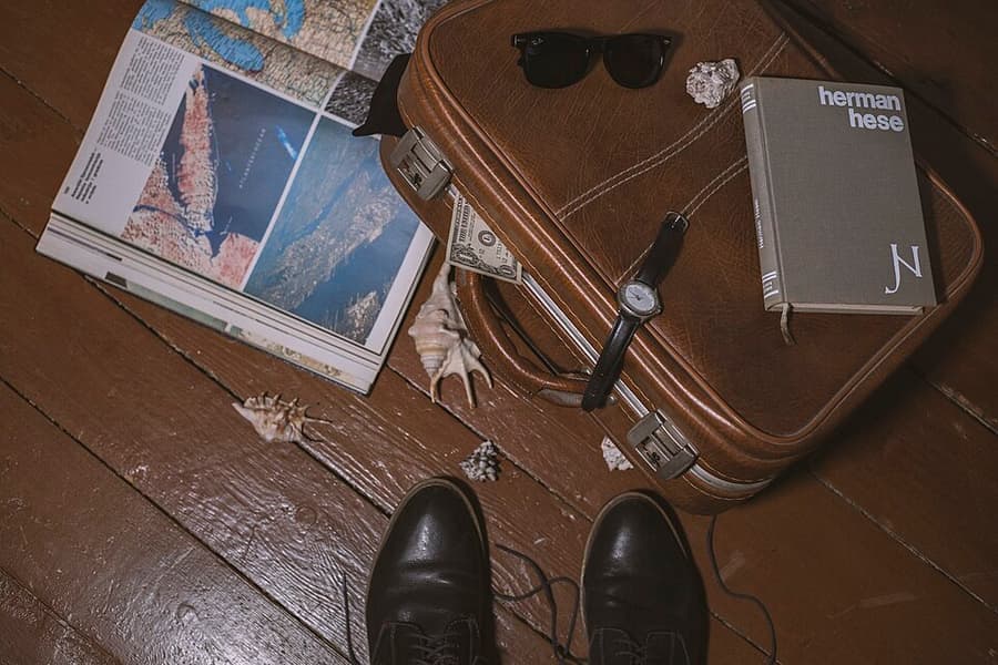 A suitcase standing ready by a doorway