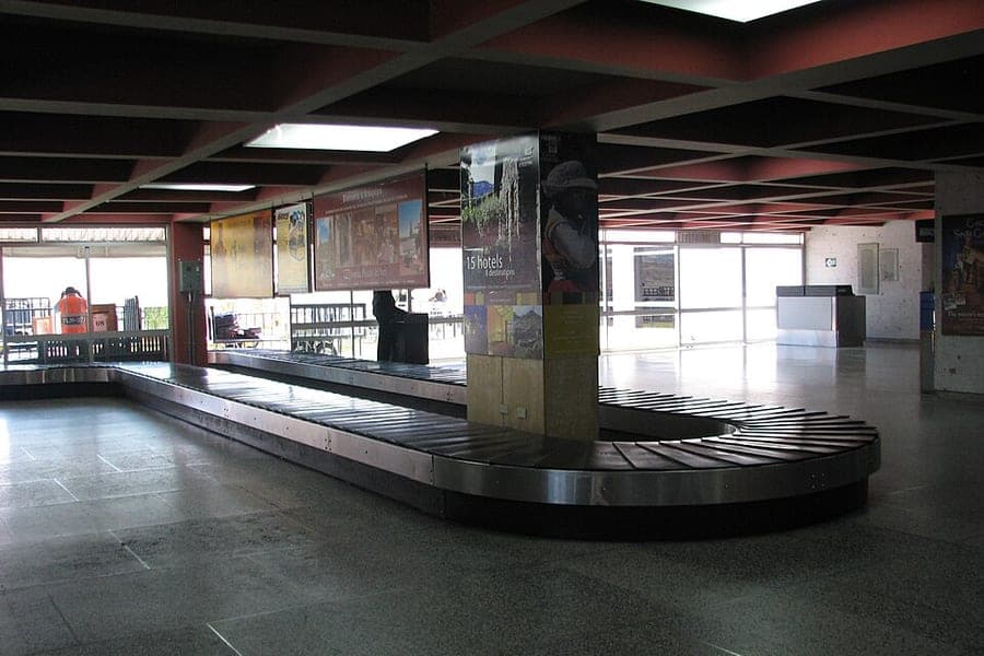 Suitcases circling on an airport baggage carousel
