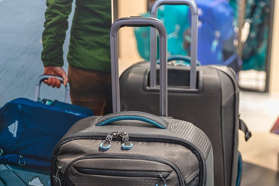 Close view of suitcase wheels and a telescoping handle