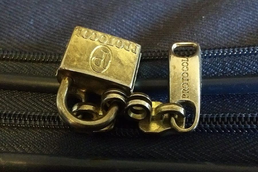 A close-up of a suitcase lock and shell