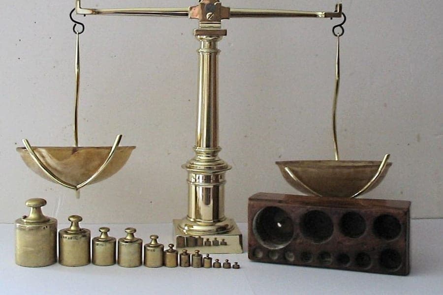 An antique balance scale with brass pans