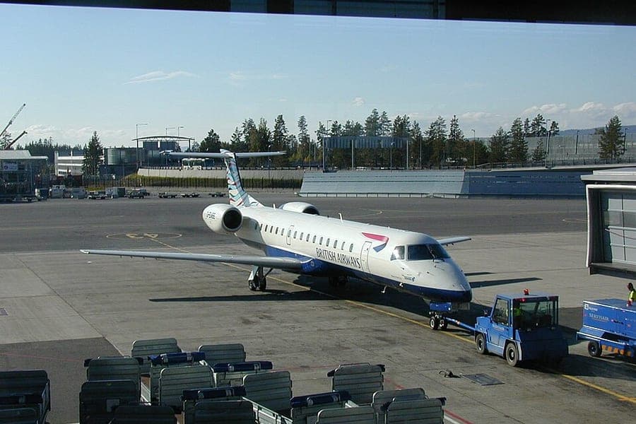 A regional jet at an airport gate