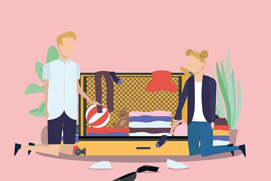 An untidily packed open suitcase with clothes spilling out