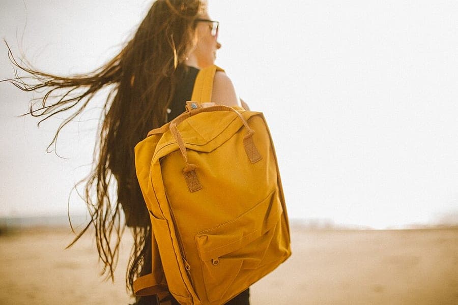 A backpack resting on a seafront wall