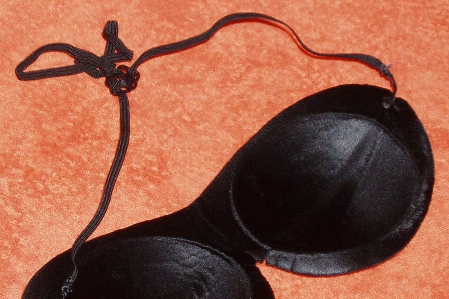 A padded sleep mask on a plain background