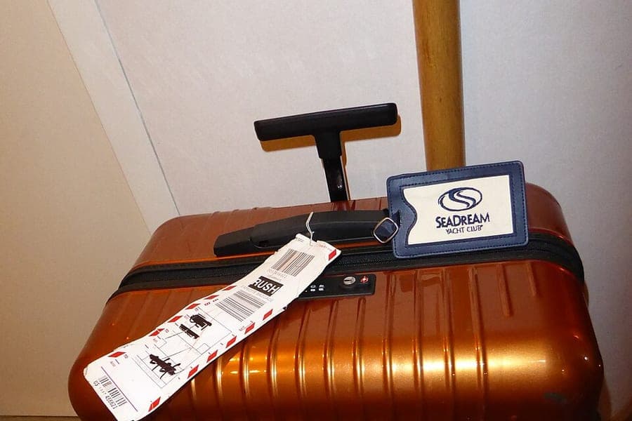 A hardside suitcase standing on a deck