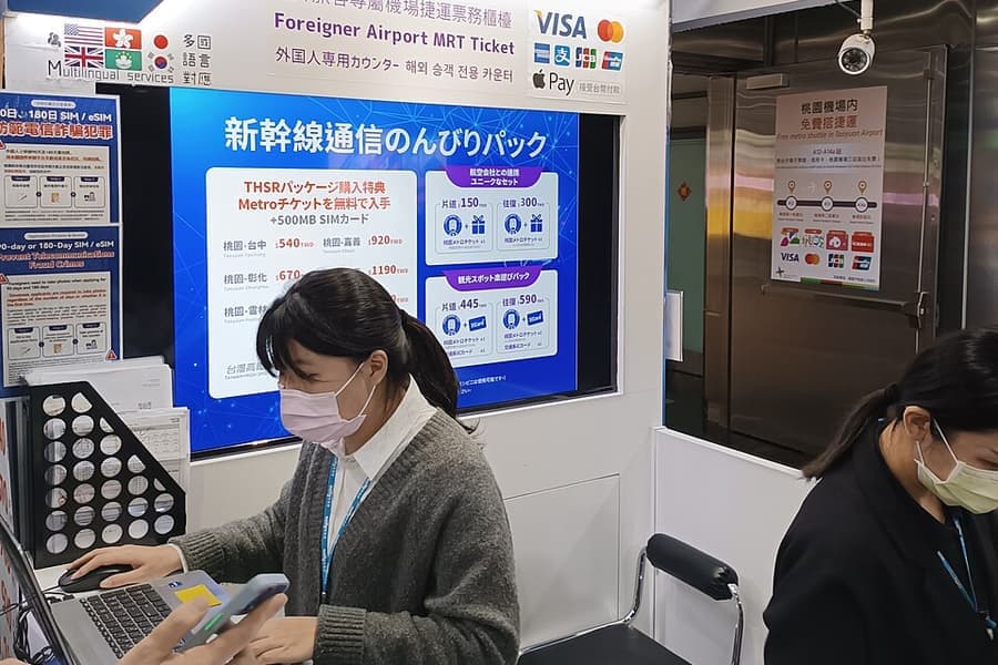 An airport terminal counter with travel documents and devices