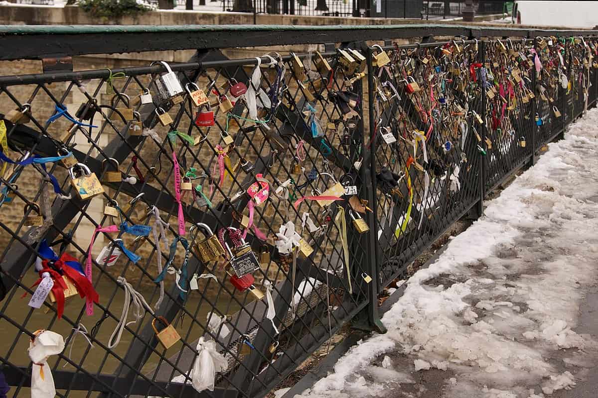 A padlock securing the zipper pulls on a suitcase